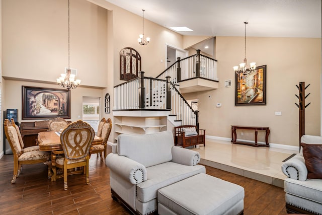 living room with stairs, dark wood finished floors, and a notable chandelier