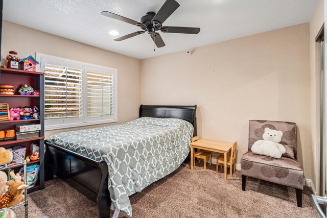 carpeted bedroom with baseboards and a ceiling fan