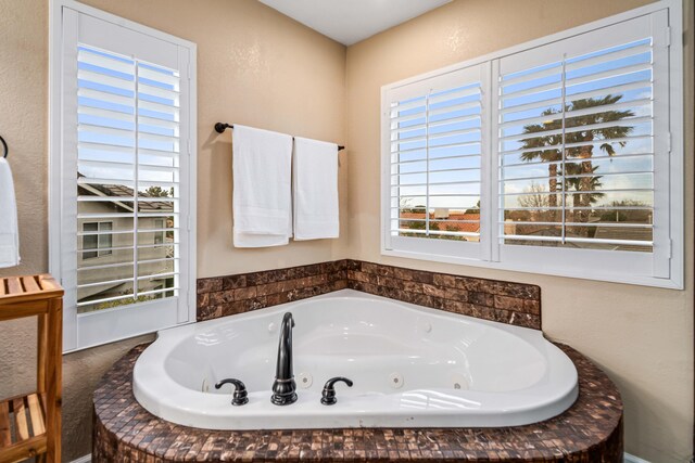 full bathroom featuring a whirlpool tub