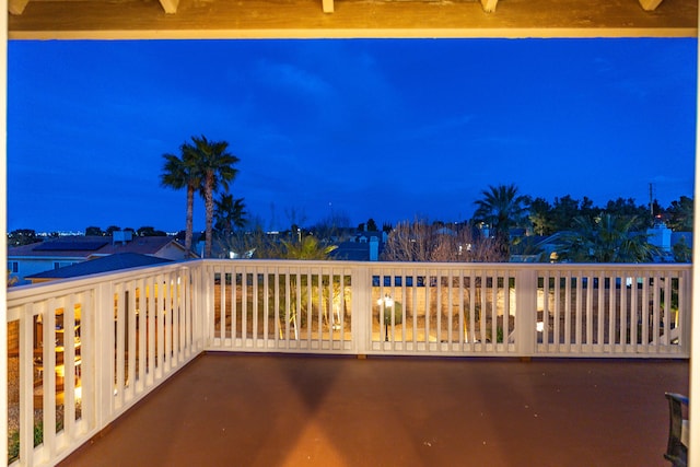 patio at night featuring a balcony
