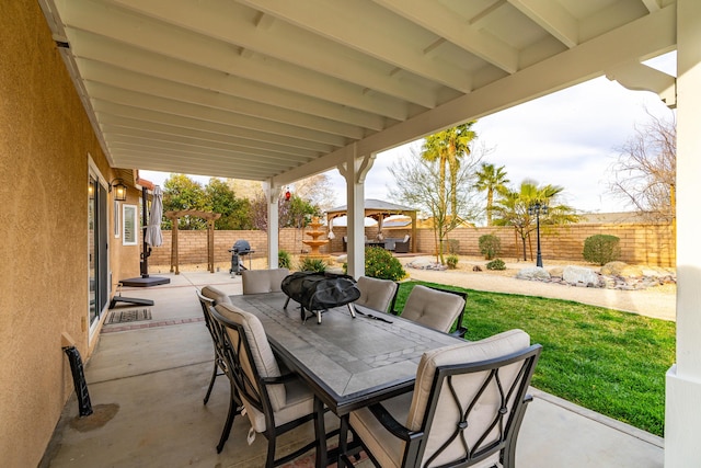 view of patio featuring outdoor dining space, a fenced backyard, and a pergola