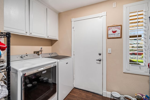 washroom featuring dark wood-type flooring, cabinet space, and separate washer and dryer