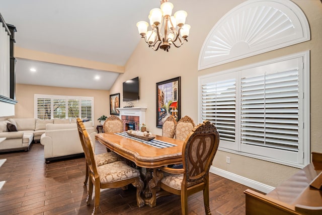 dining space featuring dark wood-style floors, a fireplace, vaulted ceiling, a chandelier, and baseboards