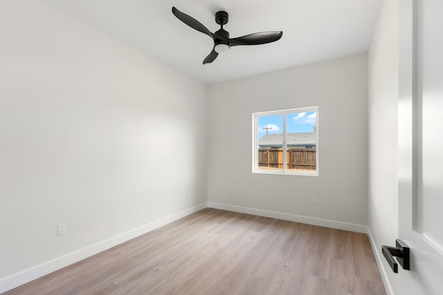 unfurnished room with a ceiling fan, light wood-style floors, and baseboards