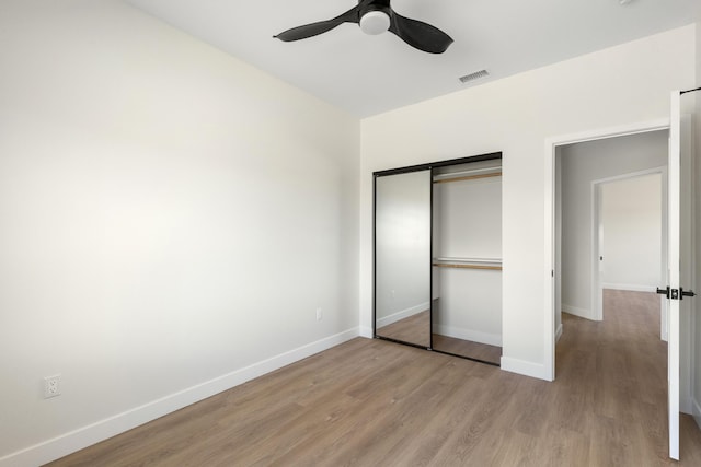 unfurnished bedroom with a ceiling fan, baseboards, visible vents, a closet, and light wood-type flooring