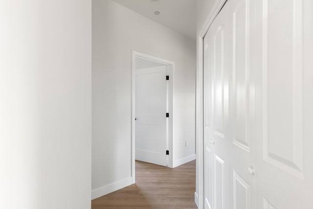 hall with light wood finished floors and baseboards