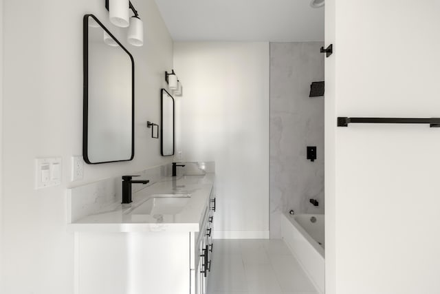 full bathroom with tile patterned floors, double vanity, a sink, tub / shower combination, and baseboards