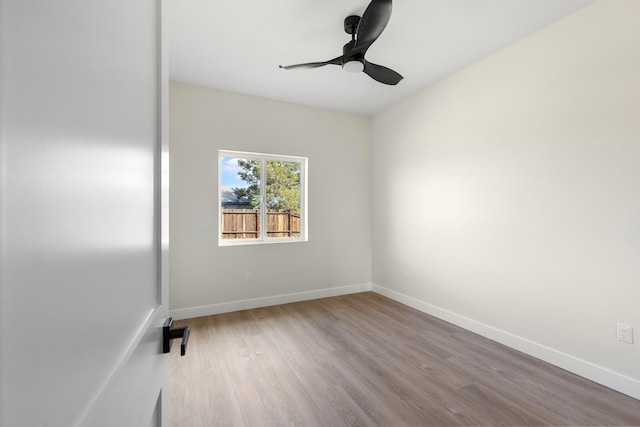 unfurnished room featuring wood finished floors, baseboards, and ceiling fan