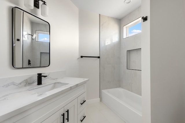 full bathroom featuring washtub / shower combination, baseboards, and vanity