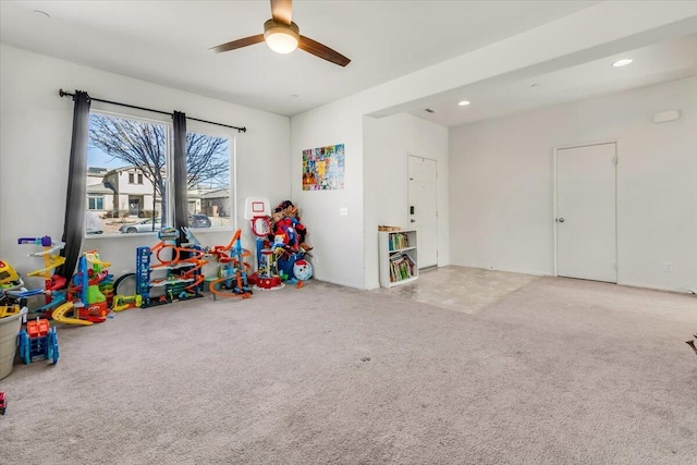 playroom featuring light colored carpet and ceiling fan