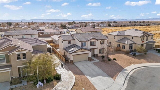 view of front of property with a mountain view and a garage