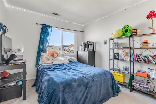 bedroom featuring light colored carpet