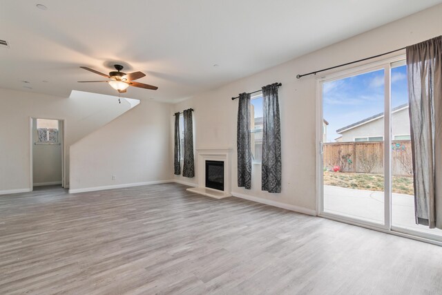 kitchen with light carpet, stainless steel dishwasher, ceiling fan, and dark stone counters