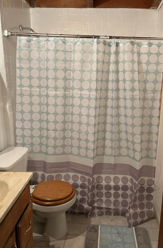 bathroom with tile patterned floors, vanity, and toilet