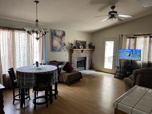 1607 E Newgrove St, Lancaster, CA 93535 - dining space with wood finished floors, a textured ceiling, vaulted ceiling, a chandelier, and ceiling fan