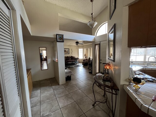 1607 E Newgrove St, Lancaster, CA 93535 - hallway with a textured ceiling, light tile patterned floors, and a high ceiling