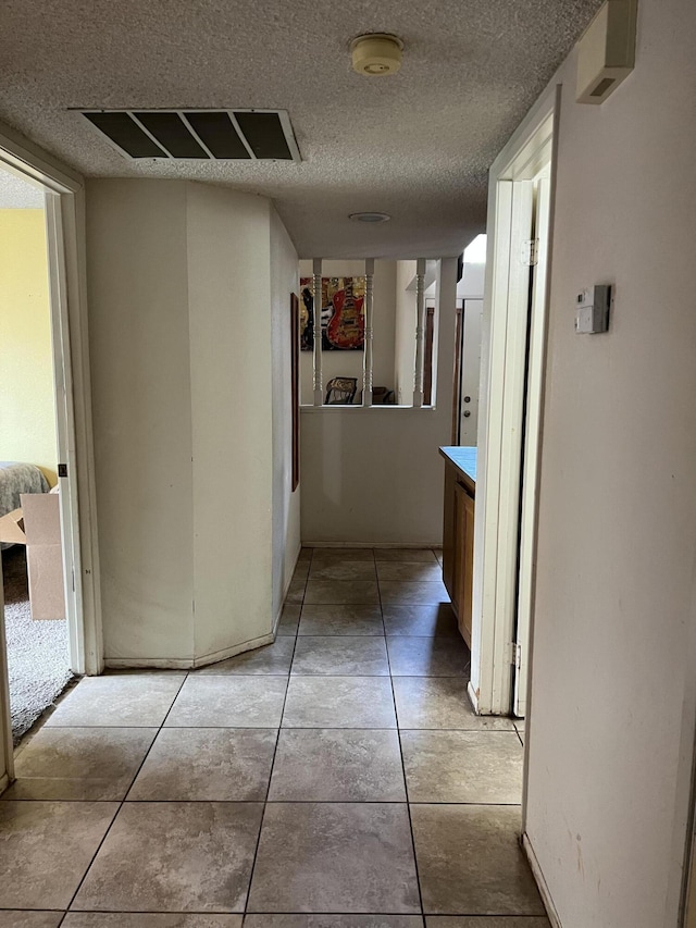 1607 E Newgrove St, Lancaster, CA 93535 - hall featuring a textured ceiling and light tile patterned floors