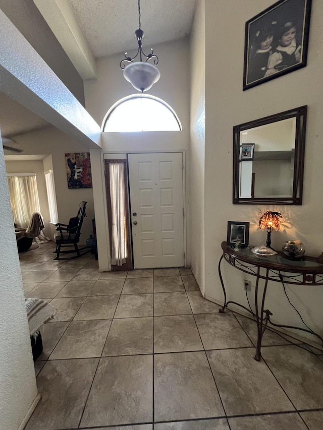 1607 E Newgrove St, Lancaster, CA 93535 - tiled entrance foyer with a textured ceiling and a high ceiling