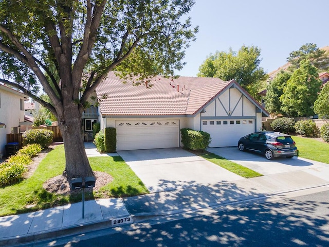 view of front of house with concrete driveway, a tile roof, and stucco siding