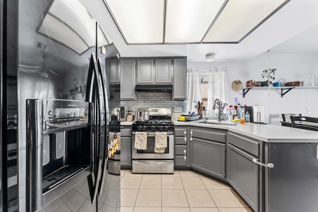 kitchen with gas stove, sink, refrigerator with ice dispenser, light tile patterned floors, and gray cabinets