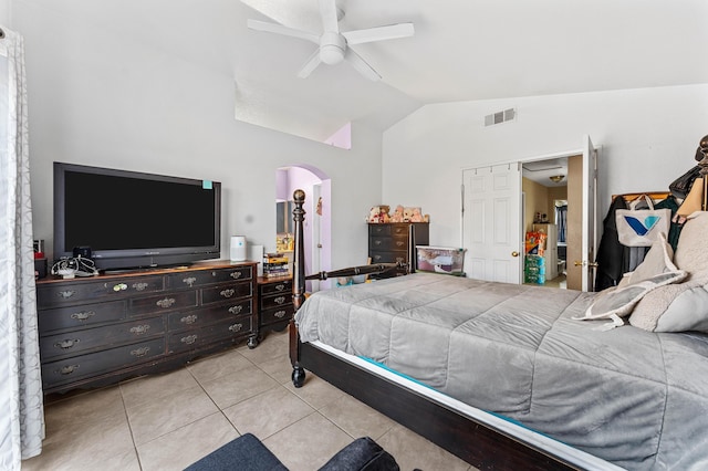 tiled bedroom with ceiling fan and vaulted ceiling