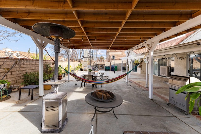 view of patio featuring heating unit and an outdoor fire pit