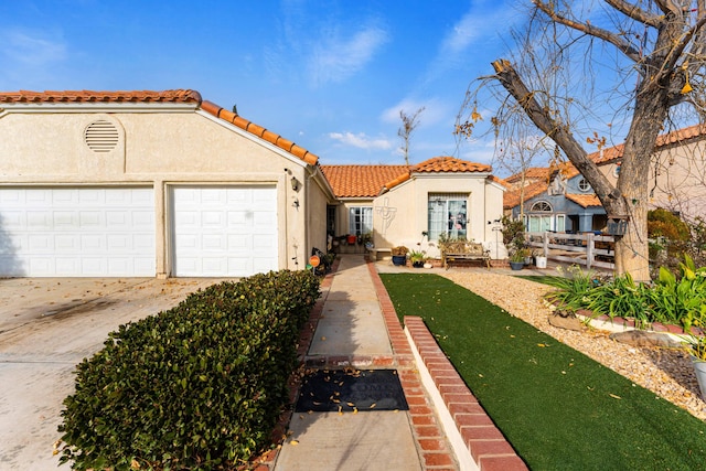 mediterranean / spanish-style house with a garage