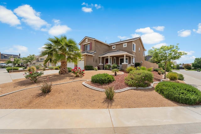 view of front of property with stucco siding, a garage, driveway, and a porch