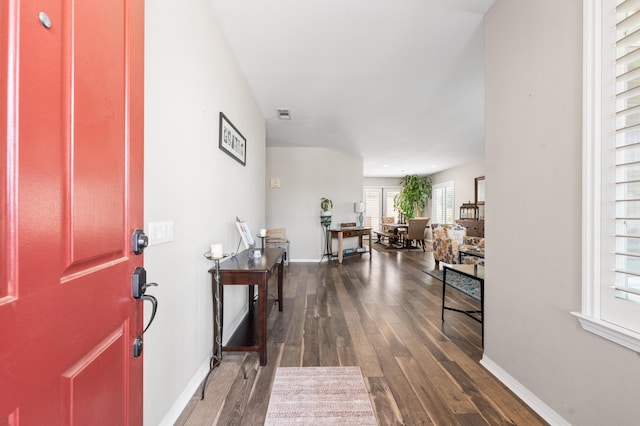 entryway featuring dark wood-type flooring and baseboards