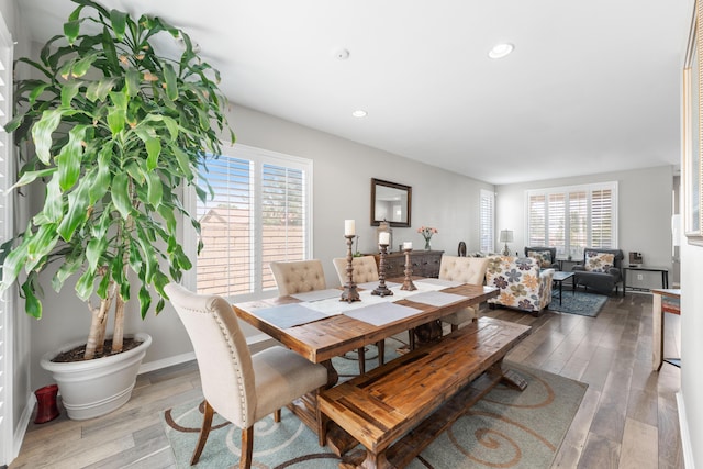 dining space featuring hardwood / wood-style floors and recessed lighting