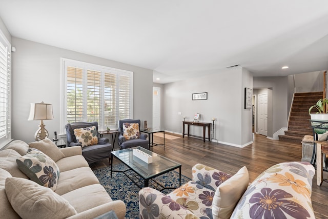 living area with wood finished floors, stairway, plenty of natural light, and recessed lighting