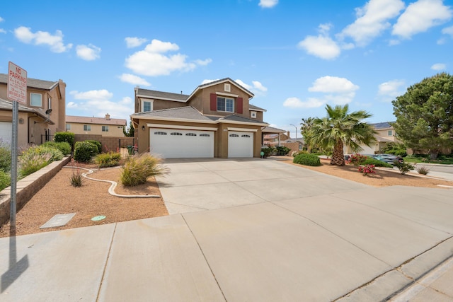 view of front of home with stucco siding, a garage, driveway, and fence