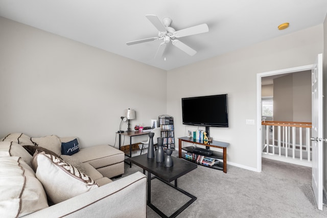 living area featuring ceiling fan, carpet floors, and baseboards