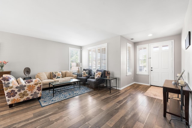 living room with dark wood-type flooring, recessed lighting, and baseboards