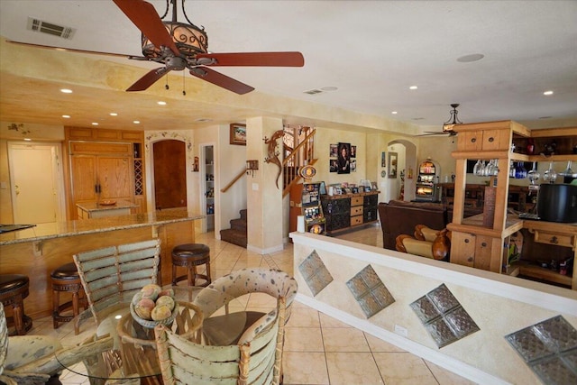 41904 Tucson Ct, Palmdale, CA 93551 - living area featuring arched walkways, light tile patterned floors, ceiling fan, recessed lighting, and stairs