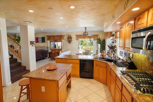 41904 Tucson Ct, Palmdale, CA 93551 - kitchen featuring stainless steel appliances, a sink, a peninsula, recessed lighting, and light tile patterned floors