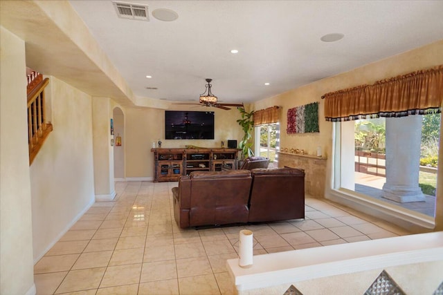 41904 Tucson Ct, Palmdale, CA 93551 - living room with arched walkways, ceiling fan, light tile patterned floors, recessed lighting, and baseboards