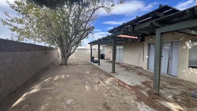 view of yard with central AC and a patio area