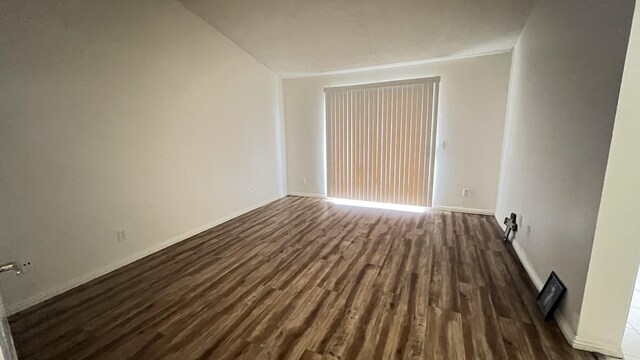 spare room with dark hardwood / wood-style flooring