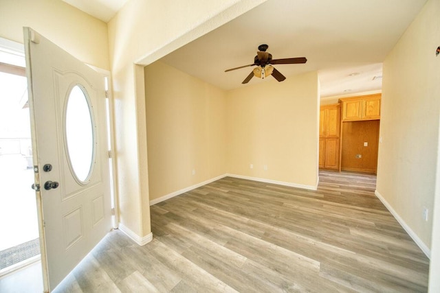 entryway featuring light wood-type flooring, baseboards, and ceiling fan