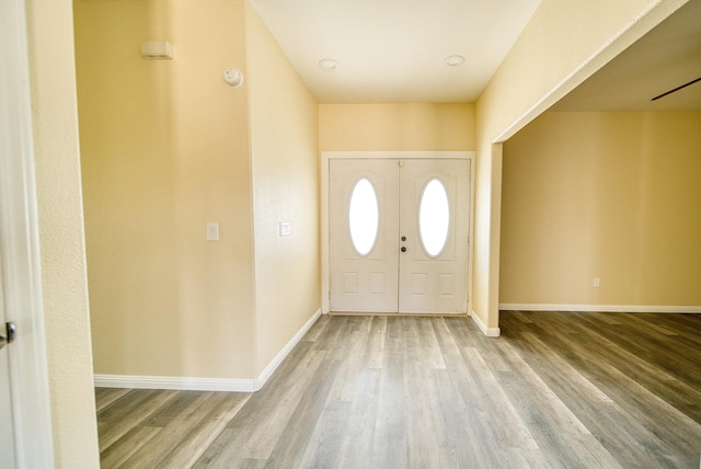 entryway featuring baseboards and wood finished floors