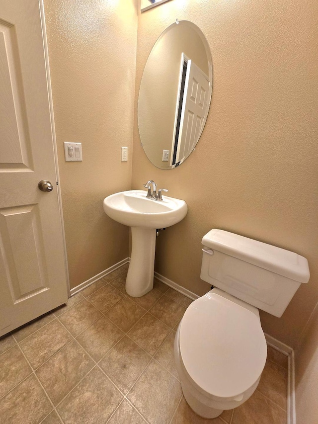 39294 Butler St, Palmdale, CA 93551 - bathroom with baseboards, tile patterned floors, and toilet