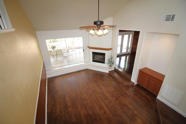 unfurnished living room featuring dark wood-style floors, a ceiling fan, and visible vents
