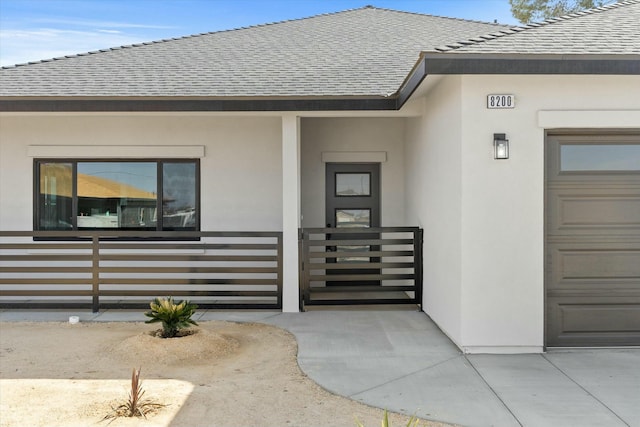 property entrance with roof with shingles and stucco siding