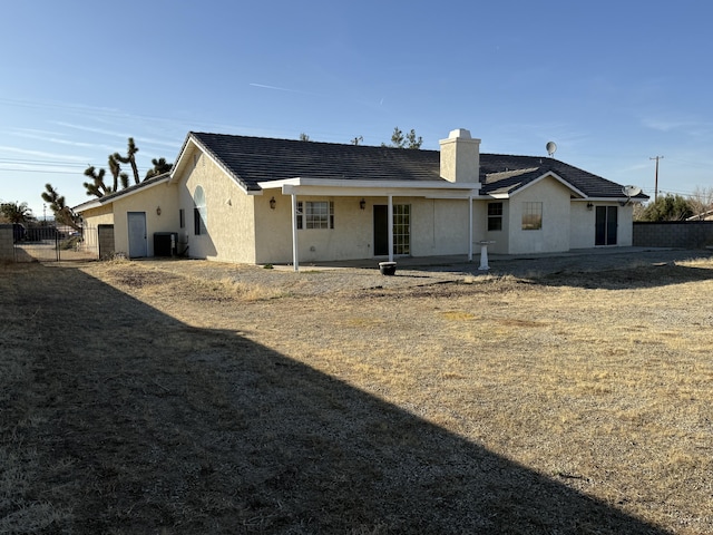 back of house with central air condition unit