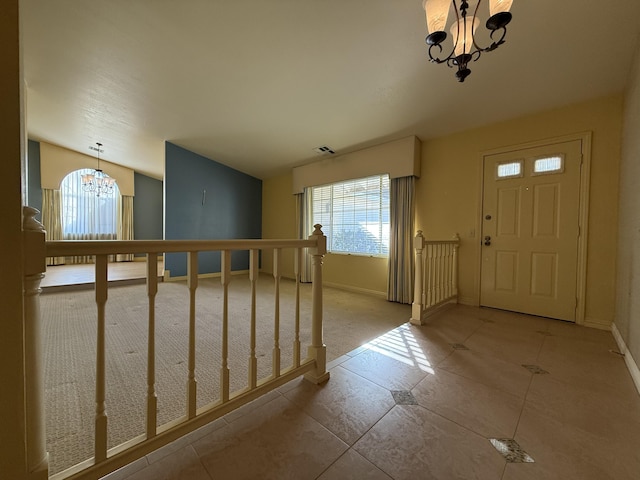 entryway featuring an inviting chandelier and a healthy amount of sunlight