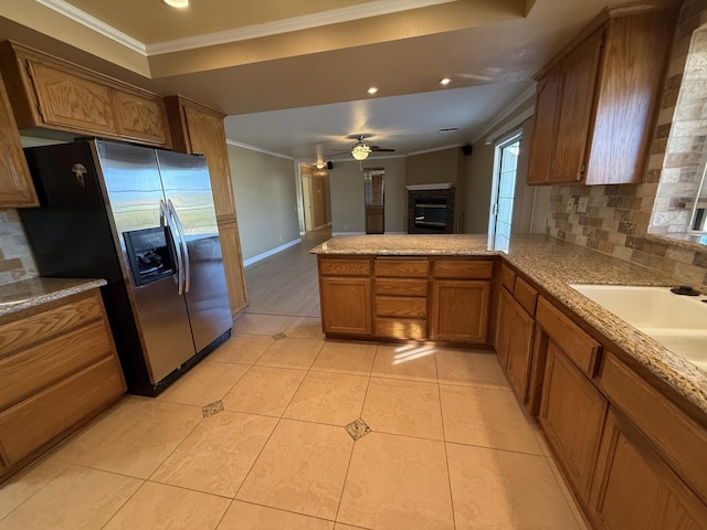 kitchen featuring stainless steel fridge with ice dispenser, crown molding, decorative backsplash, and ceiling fan