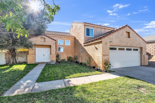 mediterranean / spanish-style home featuring a garage and a front lawn