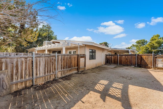 36042 E 32nd St, Palmdale, CA 93550 - back of property featuring stucco siding and a pergola