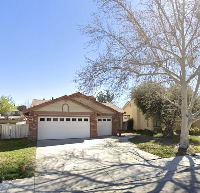 ranch-style house with driveway, fence, brick siding, and a garage